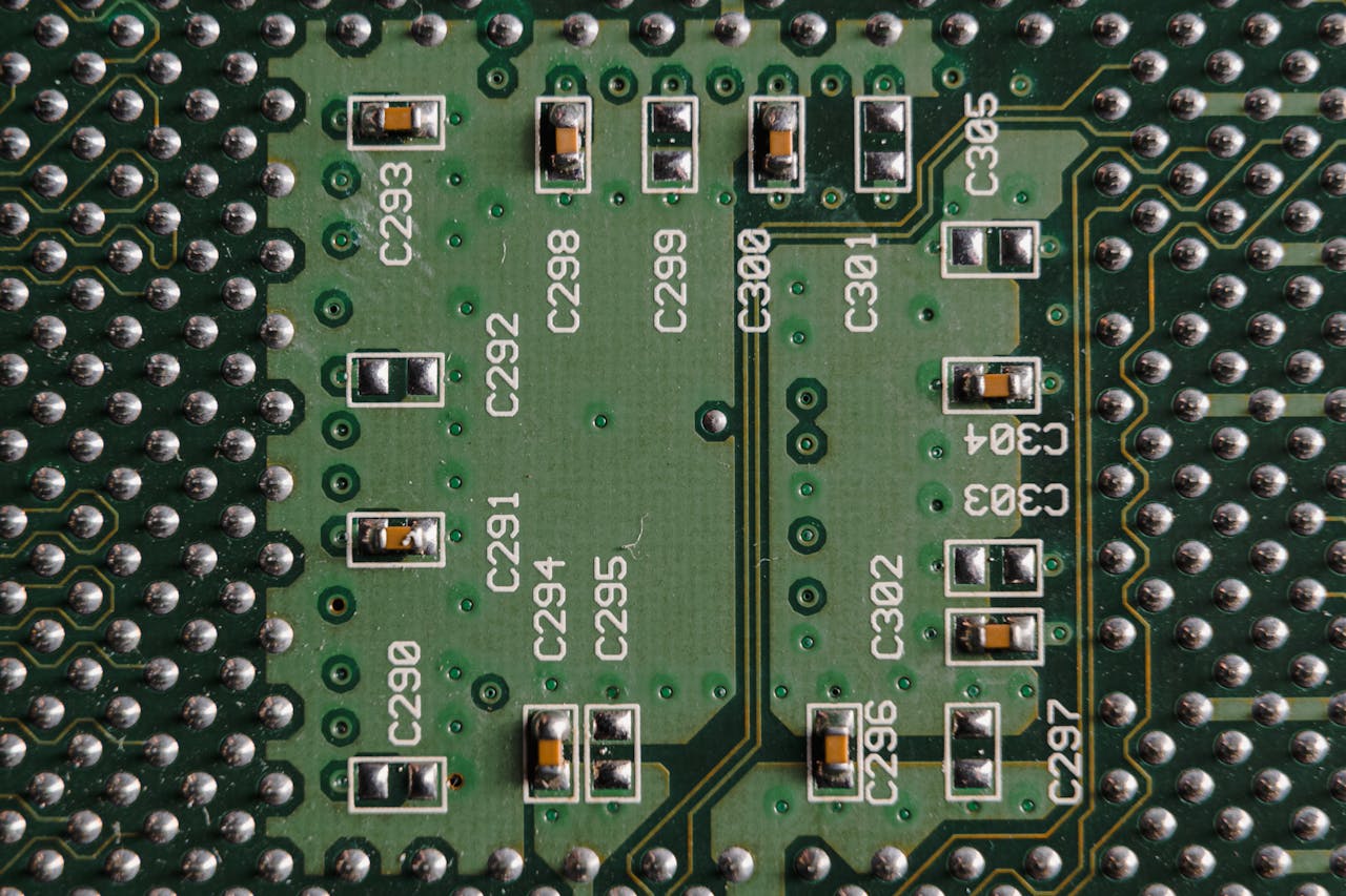 Detailed close-up of a green circuit board featuring microchips and labeled components.